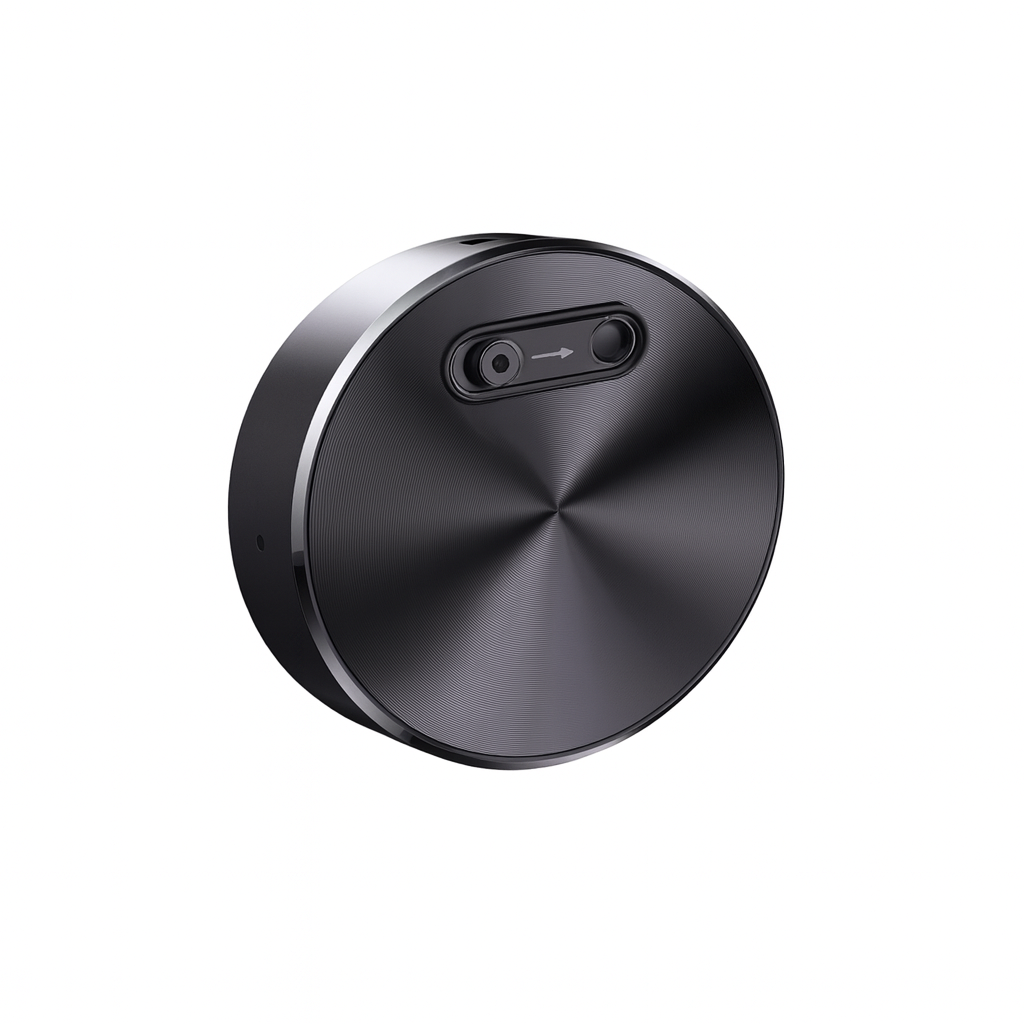 Round metallic object with a central button on a white background